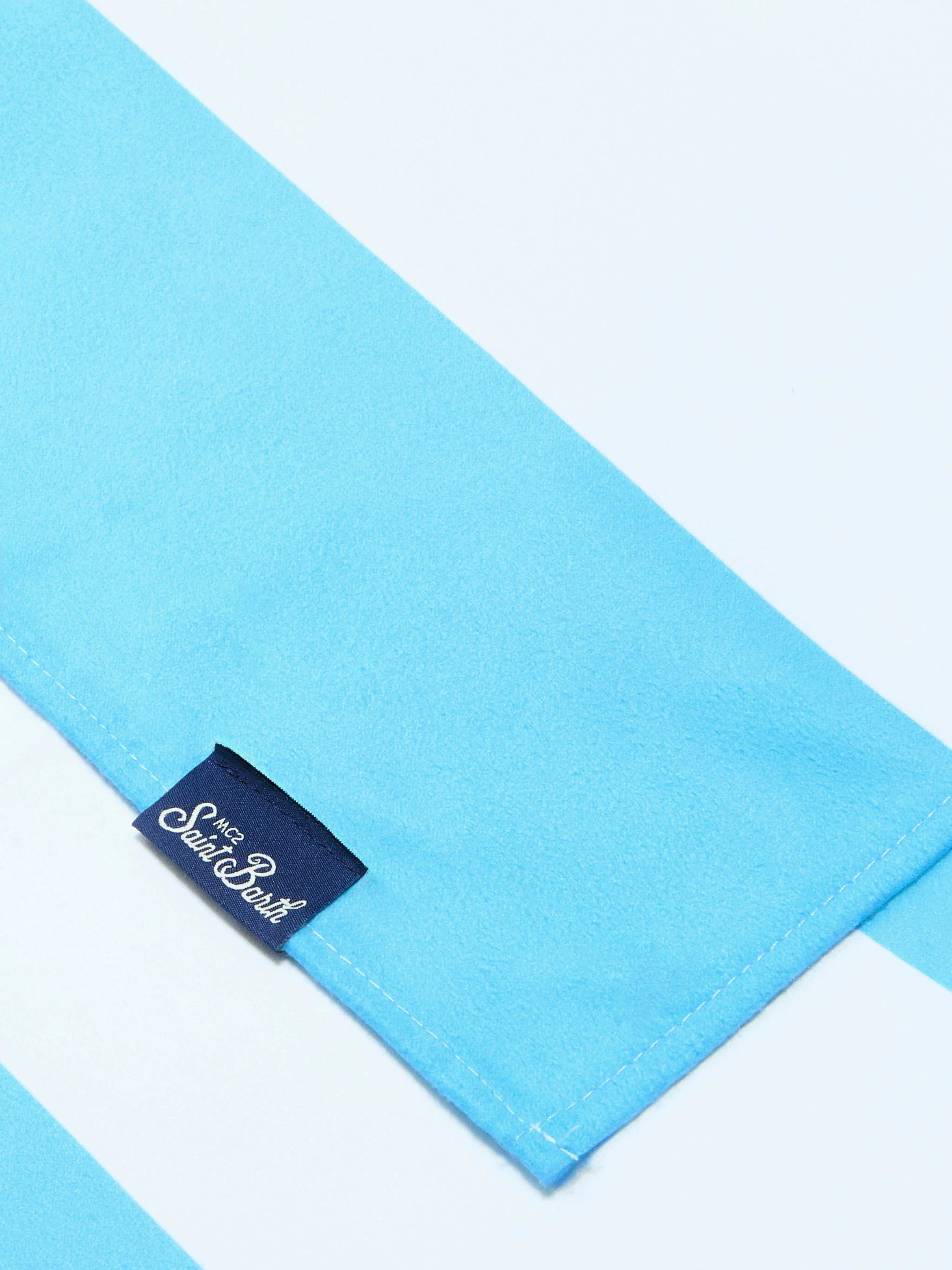Aidan beach towel with light blue and white stripes and logo - Image 2